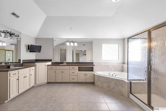 10149 Edward St, La Vista, NE 68128 - bathroom with tile patterned floors, vanity, a garden tub, a shower stall, and lofted ceiling