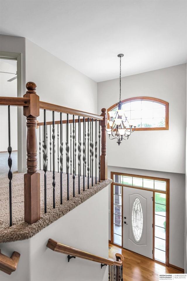 10149 Edward St, La Vista, NE 68128 - entryway featuring a chandelier, wood finished floors, and a towering ceiling