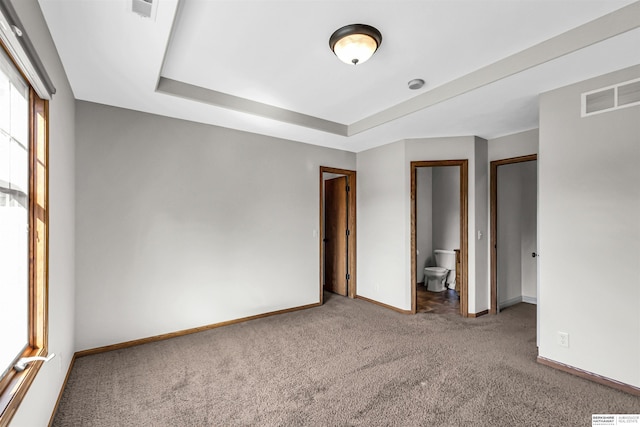 10149 Edward St, La Vista, NE 68128 - unfurnished bedroom with carpet flooring, a tray ceiling, and ensuite bathroom