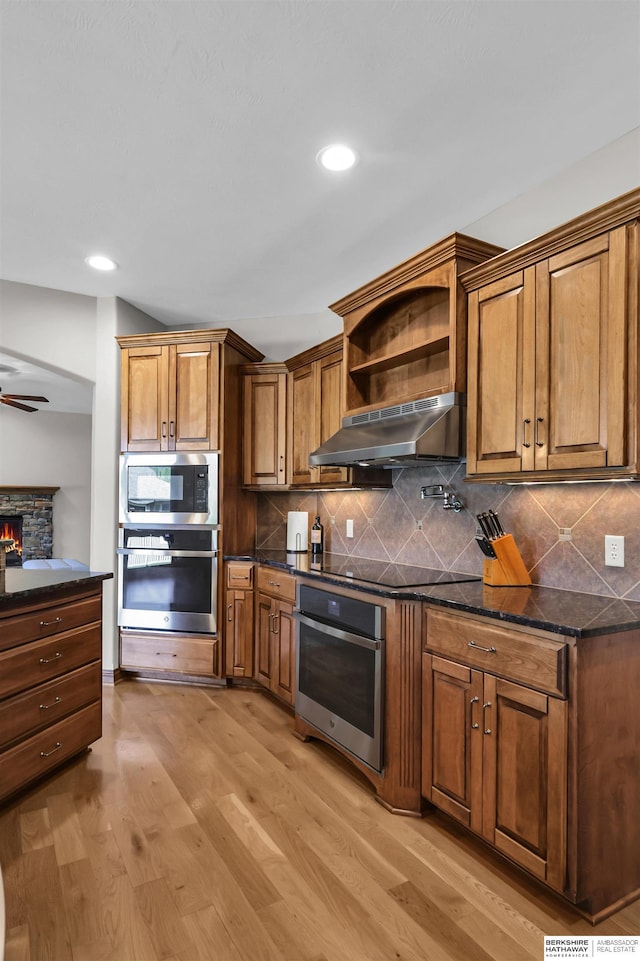 10149 Edward St, La Vista, NE 68128 - kitchen with under cabinet range hood, oven, built in microwave, black electric stovetop, and recessed lighting