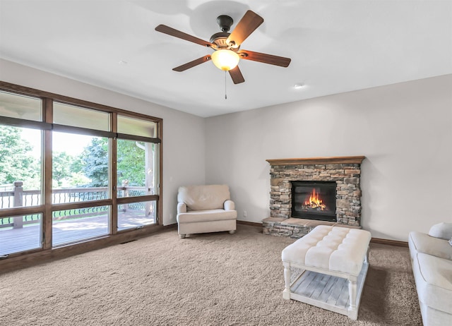 10149 Edward St, La Vista, NE 68128 - living room featuring carpet floors, a ceiling fan, and a stone fireplace
