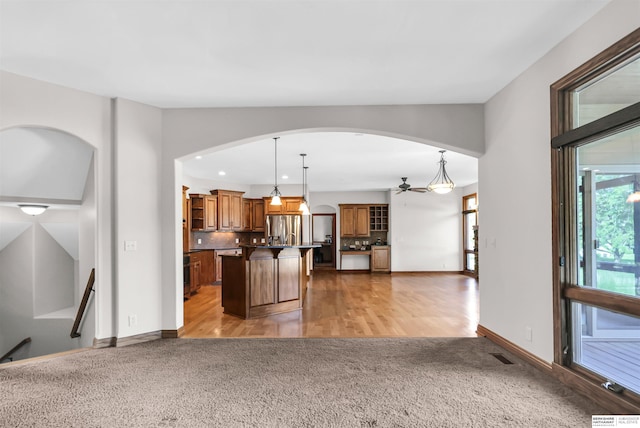 10149 Edward St, La Vista, NE 68128 - unfurnished living room with light carpet, ceiling fan, arched walkways, and recessed lighting