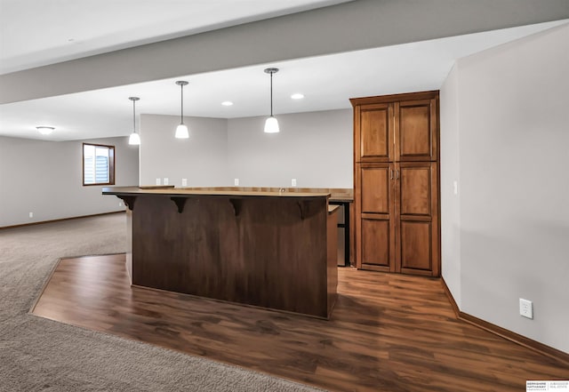 10149 Edward St, La Vista, NE 68128 - kitchen featuring a kitchen bar, decorative light fixtures, recessed lighting, dark carpet, and a kitchen island