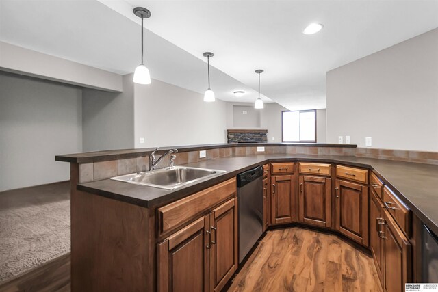 10149 Edward St, La Vista, NE 68128 - kitchen with dark countertops, stainless steel dishwasher, wood finished floors, and decorative light fixtures
