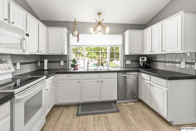 18667 R St, Omaha, NE 68135 - kitchen with white appliances, white cabinetry, dark countertops, decorative backsplash, and lofted ceiling