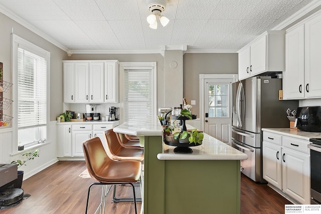 1139 E 5th St, Fremont, NE 68025 - kitchen featuring light countertops, white cabinetry, dark wood-style flooring, and ornamental molding