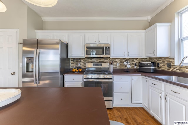11351 S 198th St, Gretna, NE 68028 - kitchen featuring stainless steel appliances, dark countertops, decorative backsplash, crown molding, and white cabinets