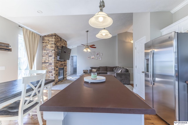 11351 S 198th St, Gretna, NE 68028 - dining area featuring a ceiling fan, lofted ceiling, and a stone fireplace