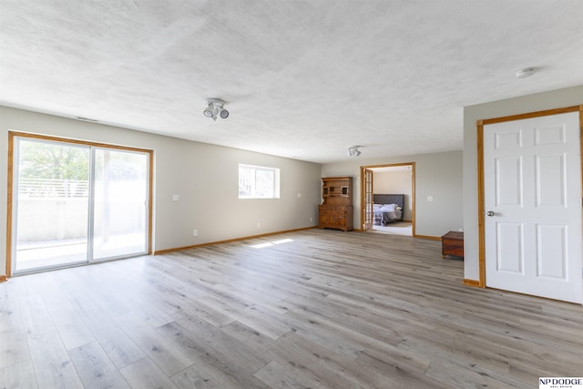 11351 S 198th St, Gretna, NE 68028 - unfurnished living room with plenty of natural light, wood finished floors, and a textured ceiling