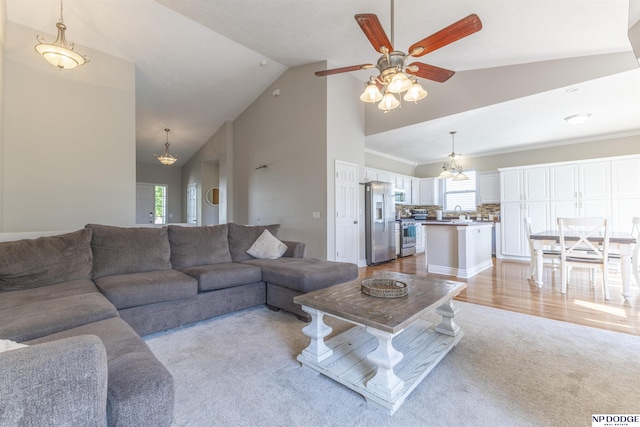 11351 S 198th St, Gretna, NE 68028 - living room featuring light carpet, healthy amount of natural light, high vaulted ceiling, ceiling fan, and a chandelier