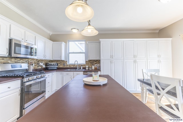 11351 S 198th St, Gretna, NE 68028 - kitchen with stainless steel appliances, dark countertops, decorative backsplash, white cabinets, and crown molding