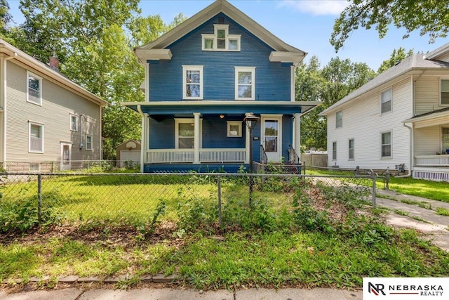 3229 R St, Lincoln, NE 68503 - view of front of property with a porch and a fenced front yard