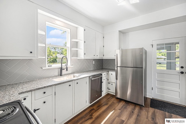 5120 Evans St, Omaha, NE 68104 - kitchen with appliances with stainless steel finishes, dark wood-style flooring, white cabinetry, light stone counters, and plenty of natural light