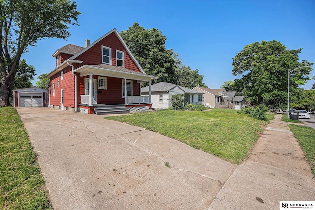 5120 Evans St, Omaha, NE 68104 - bungalow-style home featuring an outdoor structure, driveway, covered porch, a garage, and a front yard