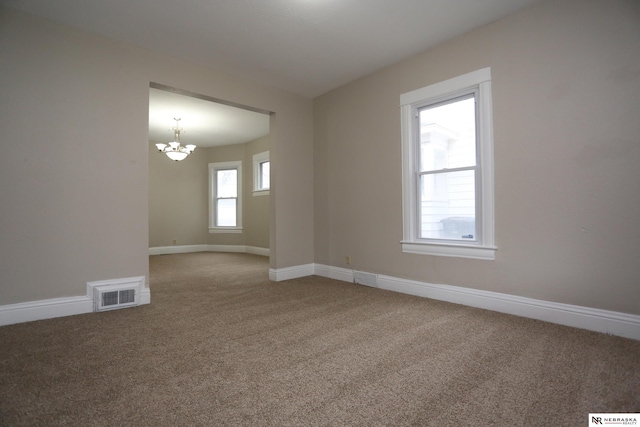 809 S 36th St, Omaha, NE 68105 - unfurnished room with a chandelier and light carpet