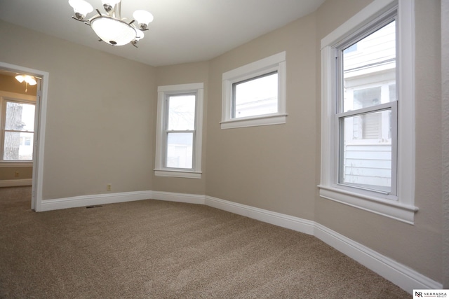 809 S 36th St, Omaha, NE 68105 - carpeted spare room with a chandelier and baseboards