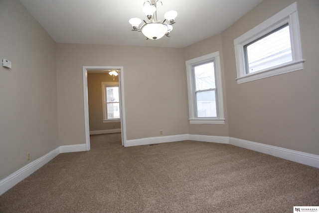 809 S 36th St, Omaha, NE 68105 - empty room with carpet flooring and a chandelier