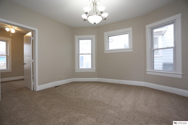 809 S 36th St, Omaha, NE 68105 - unfurnished room with a chandelier, carpet floors, and a ceiling fan