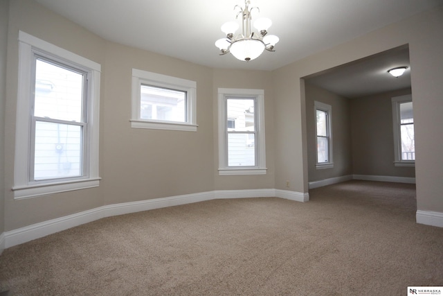 809 S 36th St, Omaha, NE 68105 - spare room with carpet, a chandelier, and healthy amount of natural light