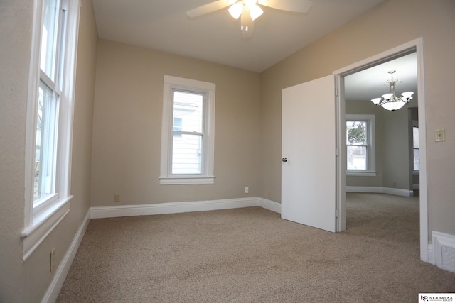 809 S 36th St, Omaha, NE 68105 - empty room with carpet, ceiling fan, and a chandelier