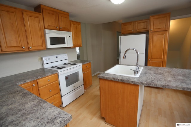 809 S 36th St, Omaha, NE 68105 - kitchen featuring white appliances, light wood-type flooring, and brown cabinetry