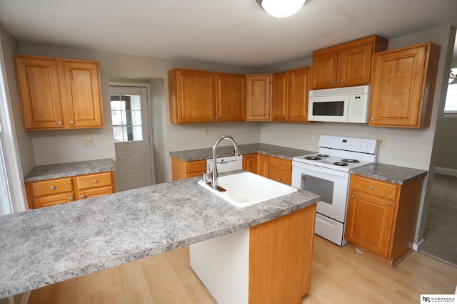 809 S 36th St, Omaha, NE 68105 - kitchen featuring white appliances, light wood-style flooring, and brown cabinetry