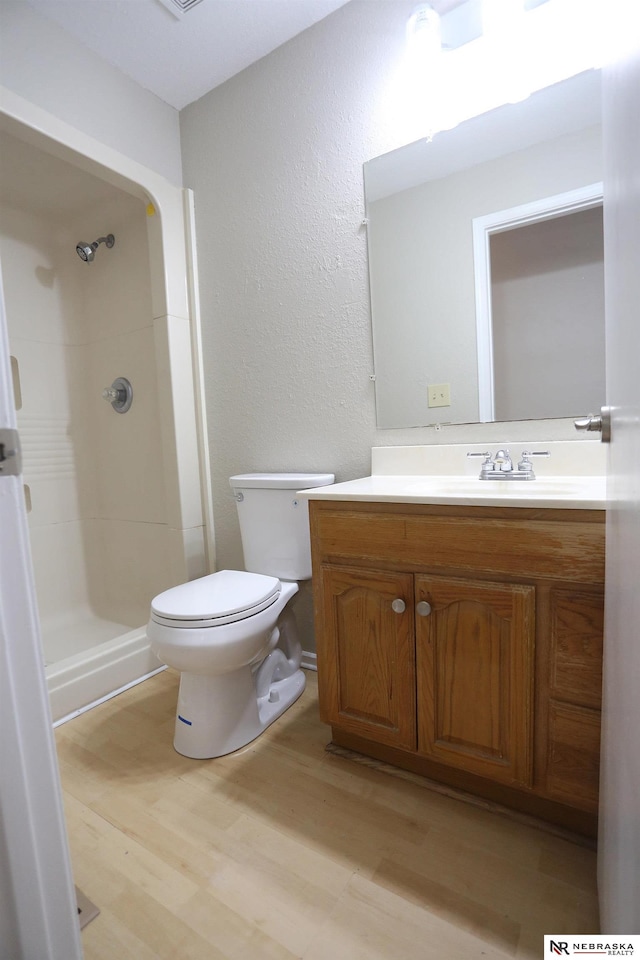 809 S 36th St, Omaha, NE 68105 - full bath with wood finished floors, vanity, a shower, and a textured wall
