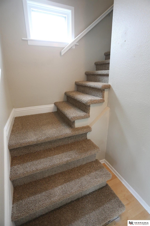 809 S 36th St, Omaha, NE 68105 - staircase with wood finished floors and baseboards