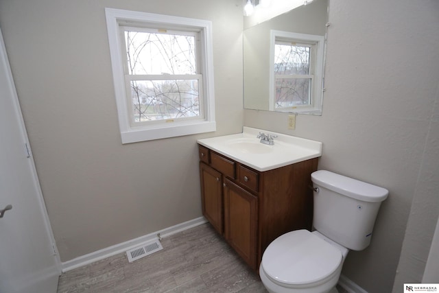 809 S 36th St, Omaha, NE 68105 - half bath featuring vanity and wood finished floors