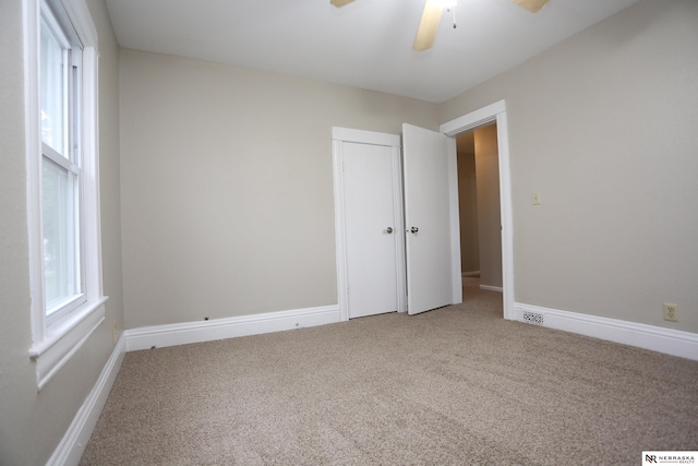 809 S 36th St, Omaha, NE 68105 - unfurnished bedroom featuring carpet floors, a closet, and ceiling fan
