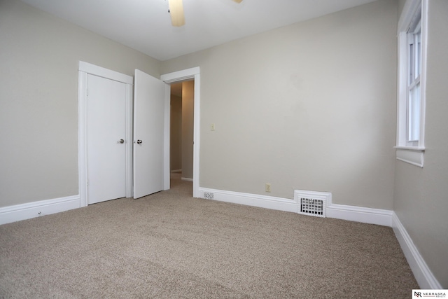 809 S 36th St, Omaha, NE 68105 - unfurnished bedroom featuring carpet floors, a closet, and a ceiling fan