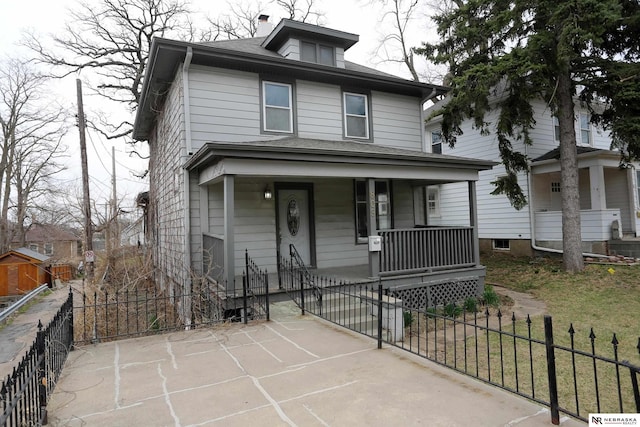 809 S 36th St, Omaha, NE 68105 - american foursquare style home with a porch and a fenced front yard
