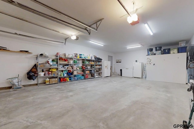 2035 355th Ave, Farragut, IA 51639 - garage featuring freestanding refrigerator and a garage door opener