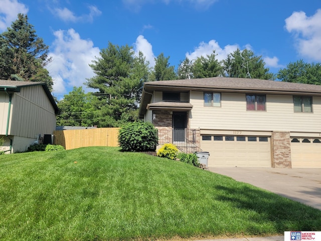 1177 N Columbia Ave, Seward, NE 68434 - view of front of property featuring an attached garage, brick siding, and driveway