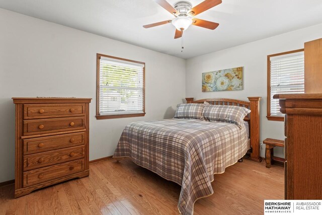 8832 Spaulding Cir, Omaha, NE 68134 - bedroom with light wood finished floors and ceiling fan