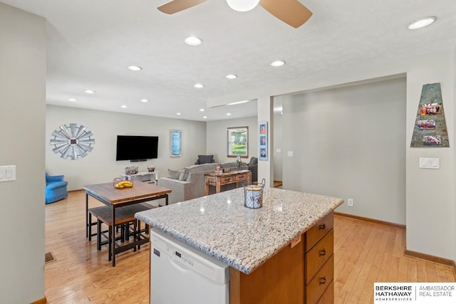 8832 Spaulding Cir, Omaha, NE 68134 - kitchen with dishwasher, light wood-type flooring, a center island, recessed lighting, and light stone countertops