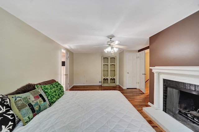 3001 Oreilly Dr, Lincoln, NE 68502 - bedroom with wood finished floors, a ceiling fan, and a fireplace with raised hearth