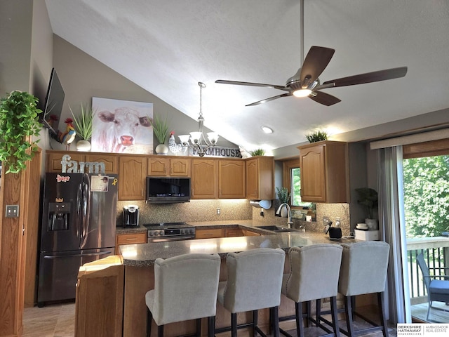 1002 Oak Ct, Plattsmouth, NE 68048 - kitchen with black fridge, stainless steel electric range oven, lofted ceiling, decorative backsplash, and a peninsula