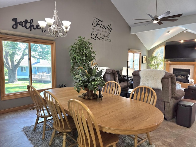 1002 Oak Ct, Plattsmouth, NE 68048 - dining space with a ceiling fan, a chandelier, a tiled fireplace, and high vaulted ceiling