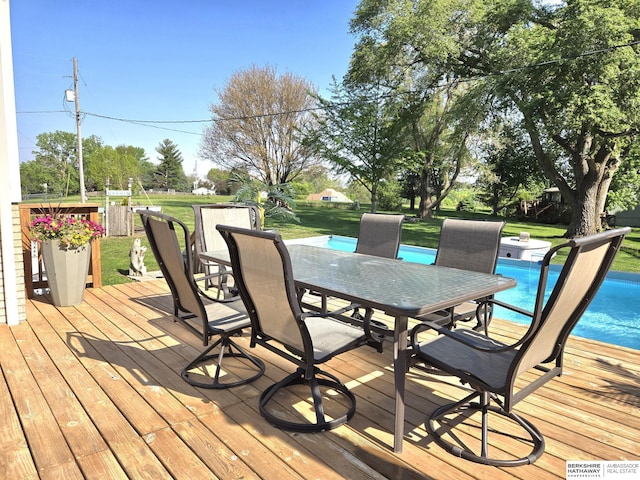 1002 Oak Ct, Plattsmouth, NE 68048 - deck with outdoor dining area, a lawn, and an outdoor pool
