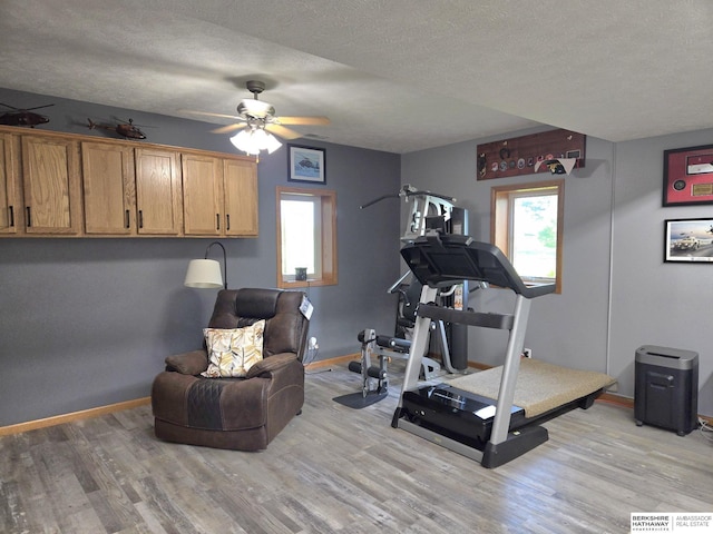 1002 Oak Ct, Plattsmouth, NE 68048 - workout room with light wood-style floors, a textured ceiling, and ceiling fan
