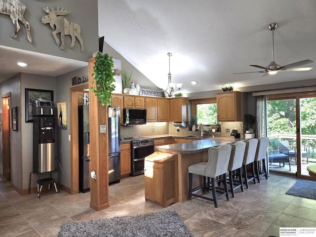 1002 Oak Ct, Plattsmouth, NE 68048 - kitchen featuring black microwave, range, fridge with ice dispenser, backsplash, and a kitchen breakfast bar
