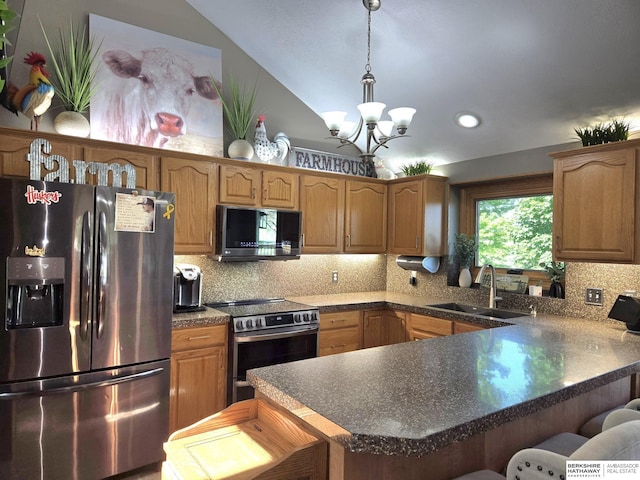 1002 Oak Ct, Plattsmouth, NE 68048 - kitchen with appliances with stainless steel finishes, a chandelier, a kitchen breakfast bar, a peninsula, and tasteful backsplash
