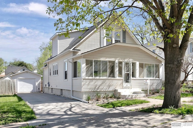 4814 Poppleton Ave, Omaha, NE 68106 - view of front facade featuring an outbuilding, concrete driveway, a garage, and a sunroom