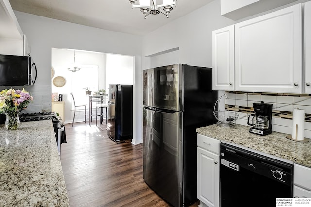 4814 Poppleton Ave, Omaha, NE 68106 - kitchen with black appliances, a chandelier, backsplash, dark wood finished floors, and white cabinetry