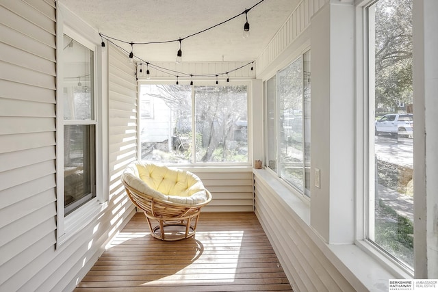 4814 Poppleton Ave, Omaha, NE 68106 - sunroom featuring wood-type flooring and a textured ceiling