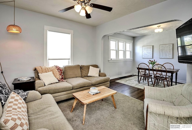 4814 Poppleton Ave, Omaha, NE 68106 - living room with arched walkways, dark wood finished floors, healthy amount of natural light, and a ceiling fan