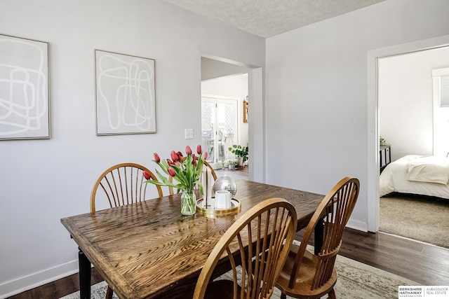 4814 Poppleton Ave, Omaha, NE 68106 - dining area with dark wood-style flooring and a textured ceiling