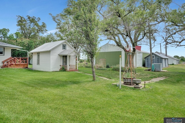 19354 SW 117th Rd, Dewitt, NE 68341 - view of green lawn with an outbuilding and a wooden deck