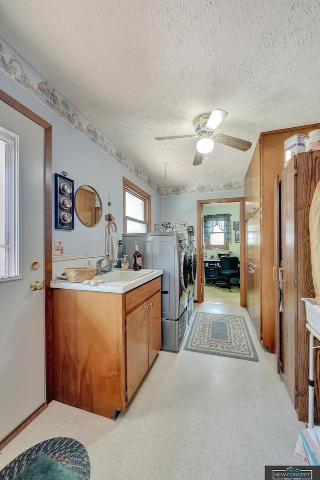 19354 SW 117th Rd, Dewitt, NE 68341 - laundry area featuring washer and dryer, a textured ceiling, ceiling fan, and cabinet space